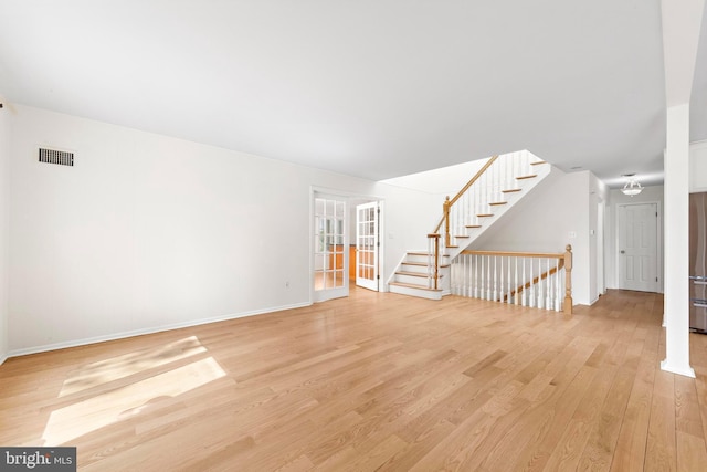 1131 Long Beach Blvd, Long Beach Township, NJ 08008 - unfurnished living room featuring light wood-type flooring, stairs, and baseboards