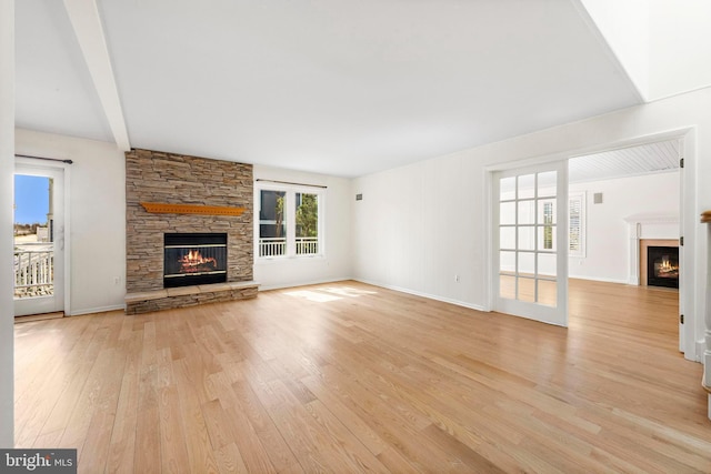 1131 Long Beach Blvd, Long Beach Township, NJ 08008 - unfurnished living room with a stone fireplace, light wood-type flooring, and baseboards