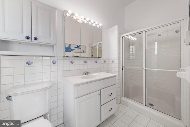 1131 Long Beach Blvd, Long Beach Township, NJ 08008 - full bathroom featuring toilet, tile walls, vanity, a shower stall, and tile patterned flooring