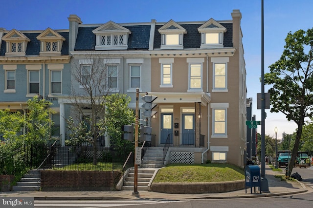 141 NE V St NE, Washington, DC 20002 - view of property featuring mansard roof and brick siding