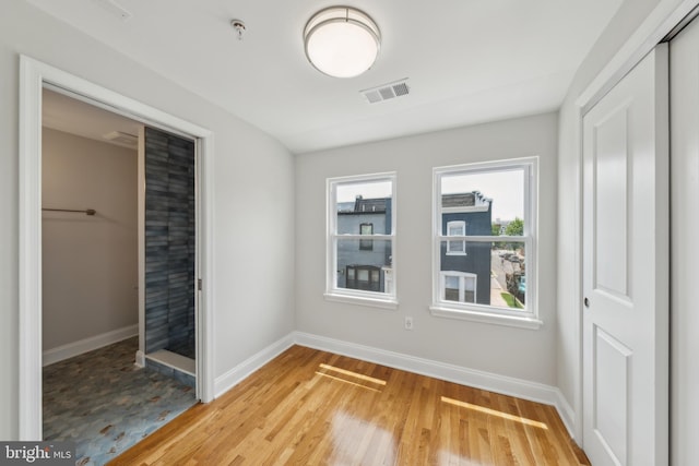 141 NE V St NE, Washington, DC 20002 - unfurnished bedroom featuring baseboards, light wood-style flooring, and a closet