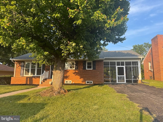 117 Washington Ave, Front Royal, VA 22630 - rear view of property featuring a lawn, brick siding, and a sunroom