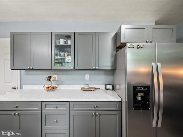 117 Washington Ave, Front Royal, VA 22630 - kitchen with stainless steel refrigerator with ice dispenser, gray cabinetry, and glass insert cabinets