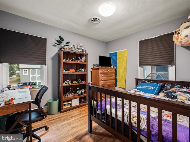 117 Washington Ave, Front Royal, VA 22630 - bedroom featuring wood finished floors, multiple windows, and an office area