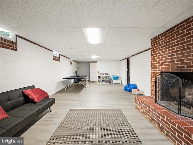 117 Washington Ave, Front Royal, VA 22630 - living room featuring wood finished floors, a drop ceiling, and a brick fireplace