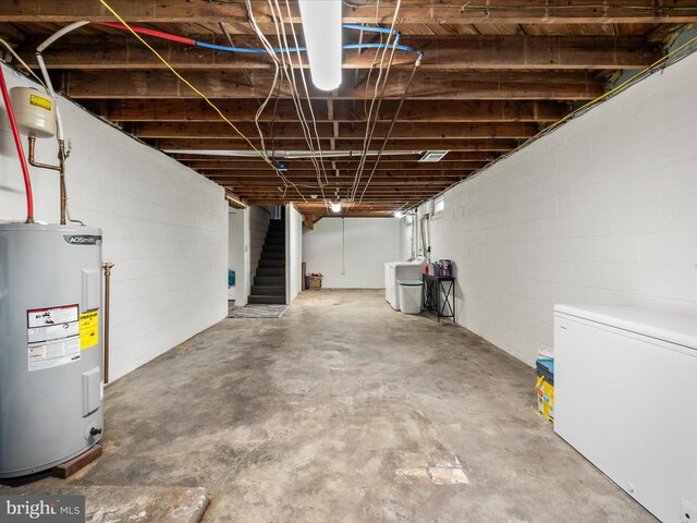 117 Washington Ave, Front Royal, VA 22630 - unfinished basement featuring water heater, white refrigerator, stairway, washer / clothes dryer, and concrete block wall