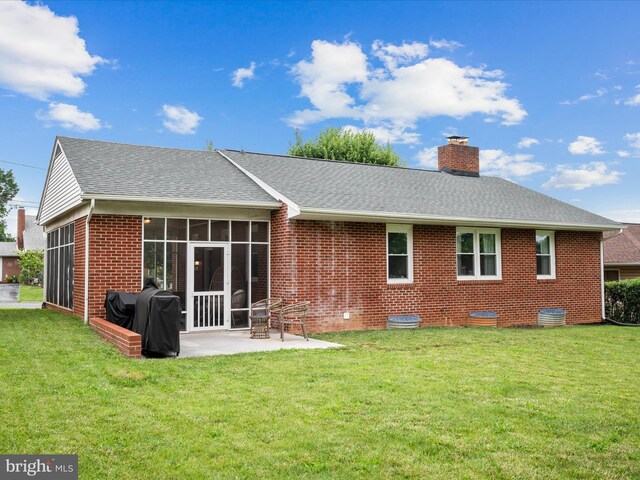 117 Washington Ave, Front Royal, VA 22630 - back of property featuring brick siding, a chimney, a shingled roof, a sunroom, and a yard