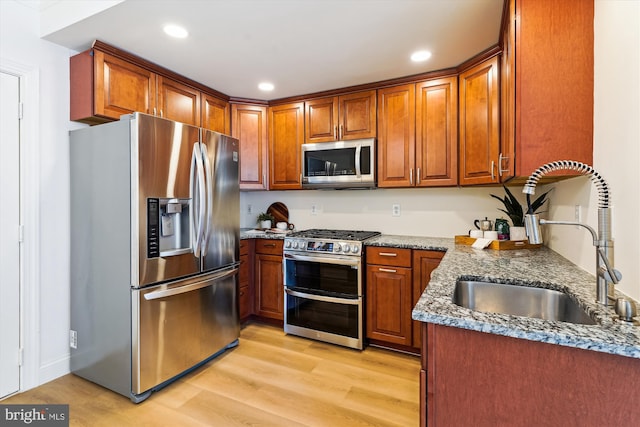 604 Highland Ridge Ave Unit 100, Gaithersburg, MD 20878 - kitchen with stainless steel appliances, dark stone countertops, light wood finished floors, brown cabinets, and recessed lighting