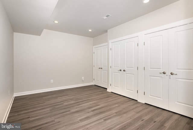 9073 Bear Branch Pl, Fairfax, VA 22031 - unfurnished bedroom featuring multiple closets, wood finished floors, recessed lighting, and baseboards