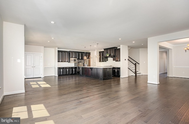 9073 Bear Branch Pl, Fairfax, VA 22031 - unfurnished living room featuring recessed lighting, stairs, baseboards, wood finished floors, and a chandelier