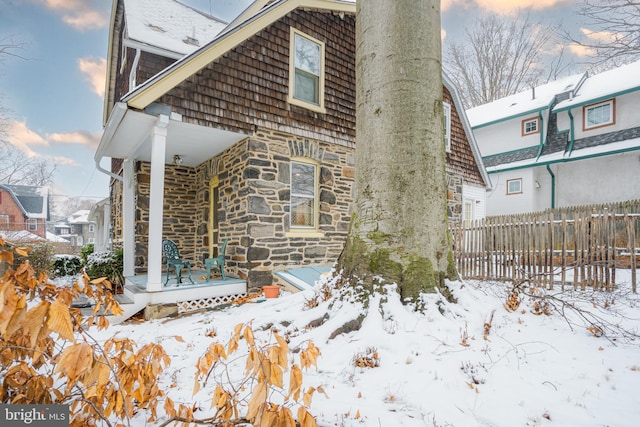 122 Merion Ave, Narberth, PA 19072 - snow covered property with stone siding and a deck