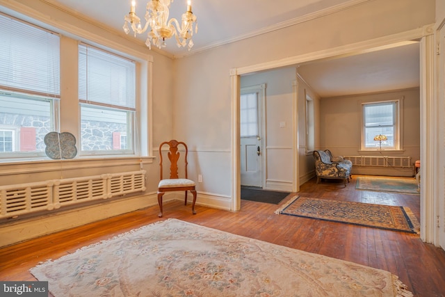 122 Merion Ave, Narberth, PA 19072 - living area featuring a chandelier, crown molding, hardwood / wood-style flooring, and radiator