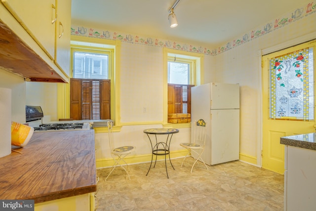 122 Merion Ave, Narberth, PA 19072 - kitchen with white appliances, light flooring, baseboards, and rail lighting
