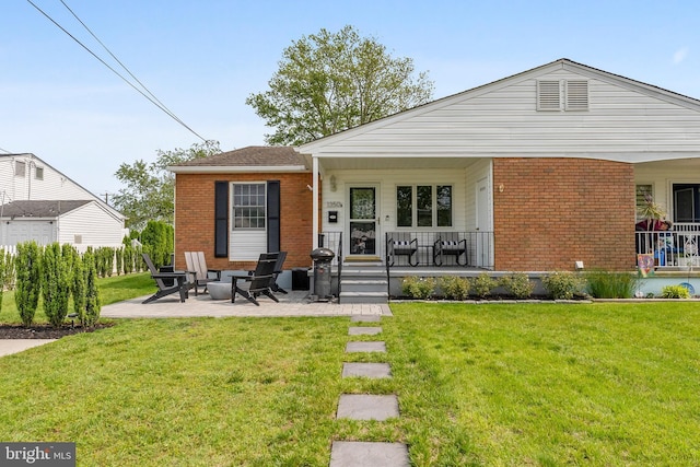 1350 Virginia Ave, Cape May, NJ 08204 - view of front of house with brick siding, a porch, and a front lawn