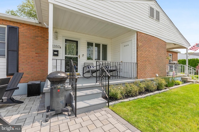 1350 Virginia Ave, Cape May, NJ 08204 - property entrance with brick siding, a porch, and a yard