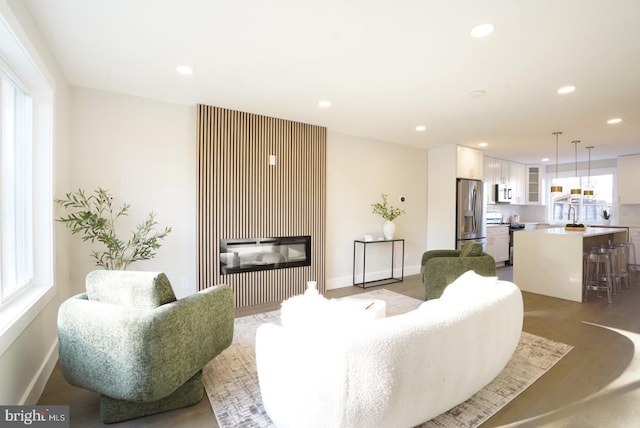 2221 15th St NE, Washington, DC 20018 - living room featuring recessed lighting, a glass covered fireplace, and baseboards