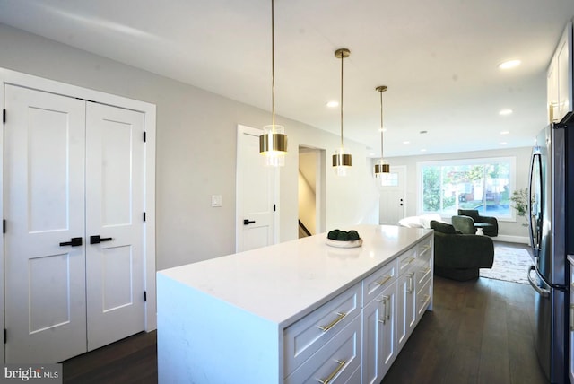 2221 15th St NE, Washington, DC 20018 - kitchen featuring freestanding refrigerator, dark wood-style flooring, a kitchen island, light countertops, and white cabinets