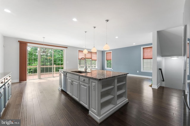 22559 Windsor Locks Sq, Ashburn, VA 20148 - kitchen featuring a sink, stainless steel dishwasher, dark wood-type flooring, a kitchen island with sink, and baseboards