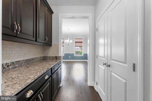 22559 Windsor Locks Sq, Ashburn, VA 20148 - kitchen featuring dark wood finished floors, baseboards, decorative backsplash, a chandelier, and light stone countertops