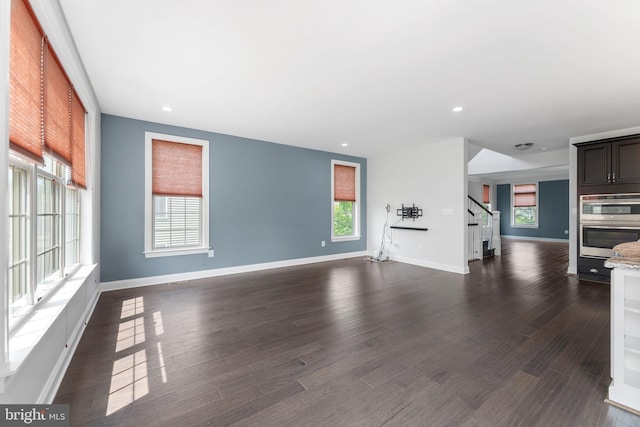 22559 Windsor Locks Sq, Ashburn, VA 20148 - unfurnished living room featuring healthy amount of natural light, stairway, dark wood-style floors, baseboards, and recessed lighting