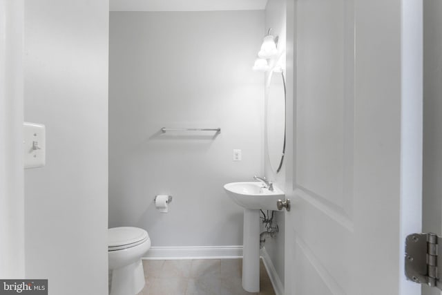 22559 Windsor Locks Sq, Ashburn, VA 20148 - half bath with tile patterned floors, toilet, and baseboards