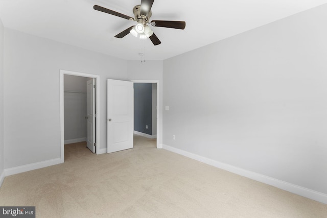 22559 Windsor Locks Sq, Ashburn, VA 20148 - unfurnished bedroom with light colored carpet, a walk in closet, baseboards, a closet, and ceiling fan