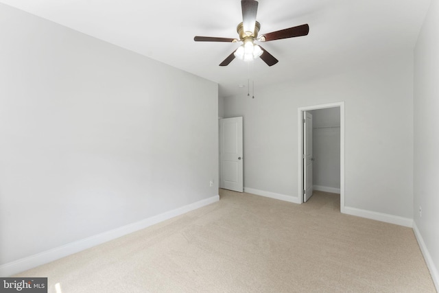 22559 Windsor Locks Sq, Ashburn, VA 20148 - unfurnished bedroom with light colored carpet, baseboards, ceiling fan, and a walk in closet