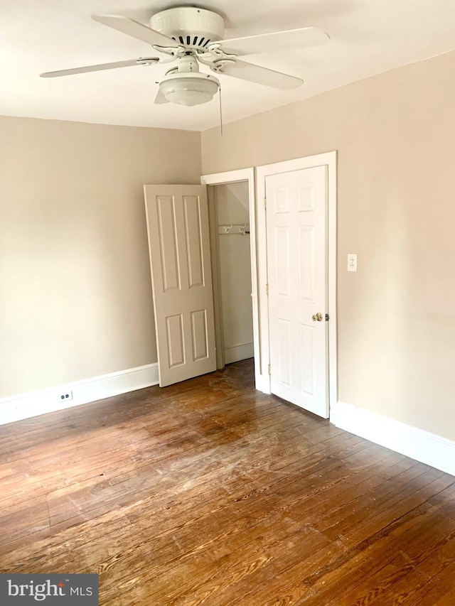42 E 5th St, New Castle, DE 19720 - unfurnished bedroom featuring dark wood-style floors, ceiling fan, and a closet