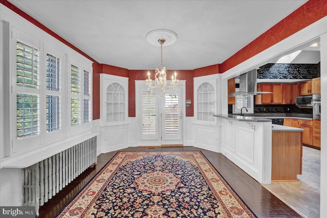 802 E Prospect Ave, North Wales, PA 19454 - unfurnished dining area with a chandelier, a sink, a decorative wall, and a wainscoted wall