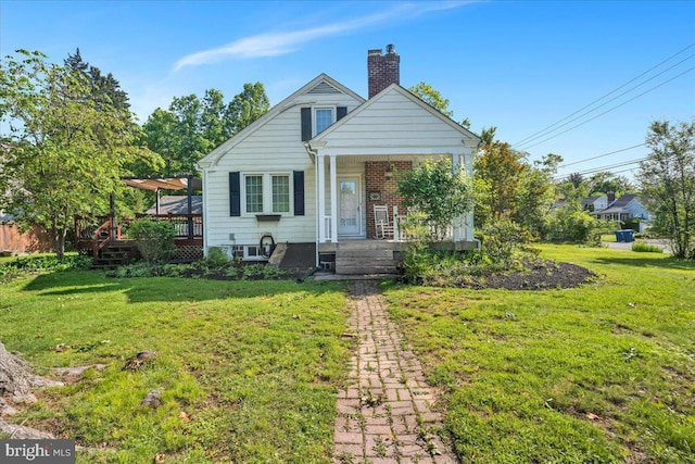 802 E Prospect Ave, North Wales, PA 19454 - bungalow-style home with a chimney, a front lawn, a porch, and a wooden deck