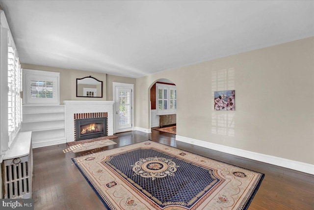 802 E Prospect Ave, North Wales, PA 19454 - living room with baseboards, a brick fireplace, plenty of natural light, and wood-type flooring