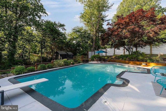 4304 Starview Ct, Glen Arm, MD 21057 - swimming pool with a patio area, a fenced backyard, a diving board, and a storage unit
