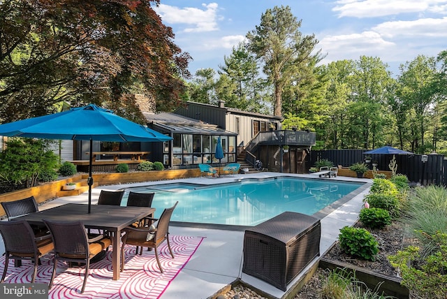 4304 Starview Ct, Glen Arm, MD 21057 - view of swimming pool featuring a fenced backyard, a wooden deck, a pool with connected hot tub, outdoor dining space, and a sunroom