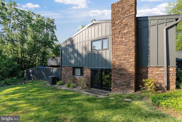 4304 Starview Ct, Glen Arm, MD 21057 - view of property exterior featuring board and batten siding, a yard, stone siding, and a chimney