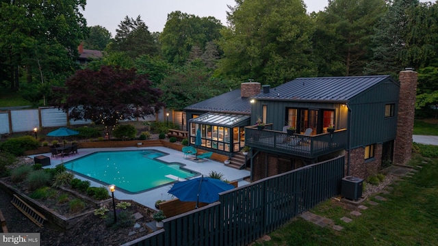 4304 Starview Ct, Glen Arm, MD 21057 - view of pool featuring a wooden deck, a patio area, stairs, a diving board, and a sunroom