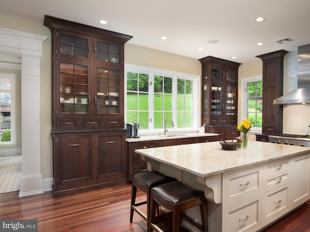 1412 Mount Pleasant Rd, Villanova, PA 19085 - kitchen featuring a sink, dark wood finished floors, wall chimney range hood, glass insert cabinets, and dark brown cabinets