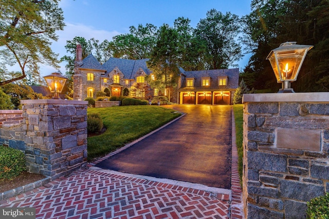 1412 Mount Pleasant Rd, Villanova, PA 19085 - view of front of property featuring driveway, a garage, a front lawn, and a chimney