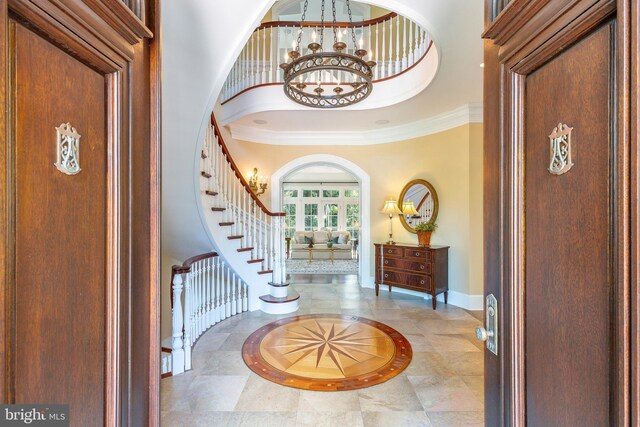 1412 Mount Pleasant Rd, Villanova, PA 19085 - foyer with inlaid floor details, baseboards, french doors, a chandelier, and crown molding