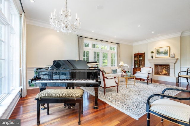 1412 Mount Pleasant Rd, Villanova, PA 19085 - sitting room featuring ornamental molding, a lit fireplace, wood finished floors, a chandelier, and wainscoting