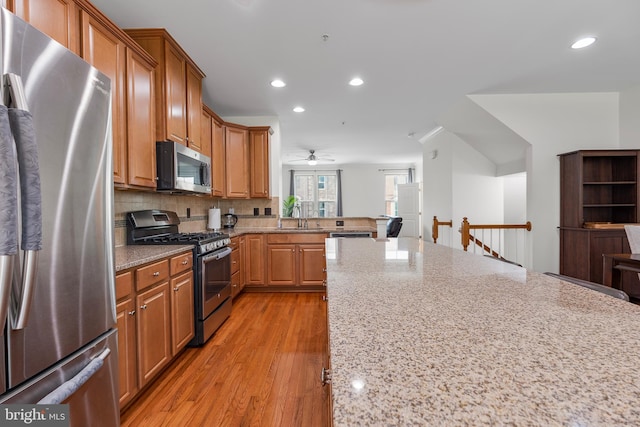 9161 Landon House Ln, Frederick, MD 21704 - kitchen featuring stainless steel appliances, a sink, recessed lighting, ceiling fan, and light stone countertops