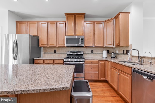 9161 Landon House Ln, Frederick, MD 21704 - kitchen featuring appliances with stainless steel finishes, a sink, light stone counters, backsplash, and recessed lighting