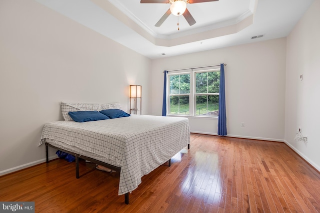 9161 Landon House Ln, Frederick, MD 21704 - bedroom featuring a tray ceiling, hardwood / wood-style floors, ornamental molding, baseboards, and a ceiling fan