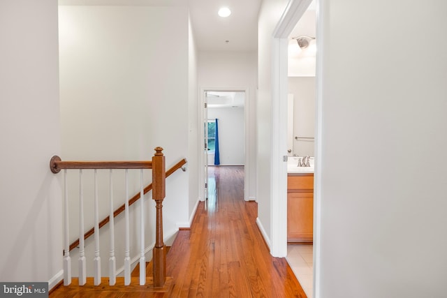9161 Landon House Ln, Frederick, MD 21704 - corridor with an upstairs landing, light wood finished floors, recessed lighting, a sink, and baseboards