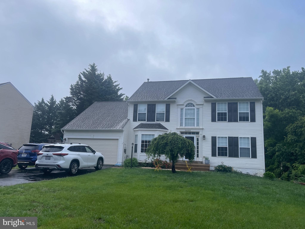 3660 Serendipity Rd, Woodbridge, VA 22193 - colonial house featuring an attached garage, a front lawn, roof with shingles, and driveway