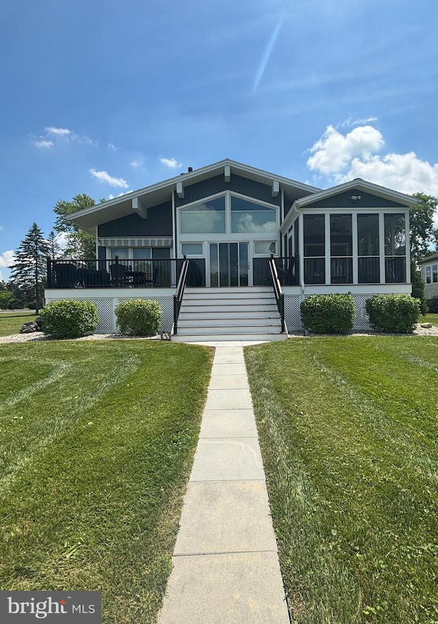 61 Bragg Dr, East Berlin, PA 17316 - back of property featuring a sunroom, a yard, and stairway
