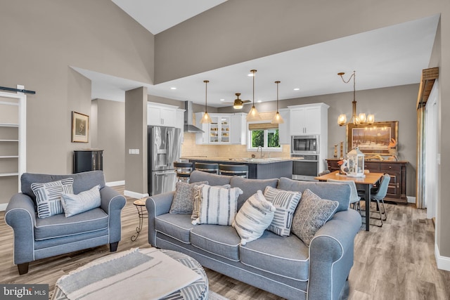 61 Bragg Dr, East Berlin, PA 17316 - living area with a chandelier, light wood-type flooring, ceiling fan, recessed lighting, and a barn door