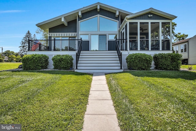 61 Bragg Dr, East Berlin, PA 17316 - view of front of home featuring a sunroom, a front yard, ceiling fan, and stairway