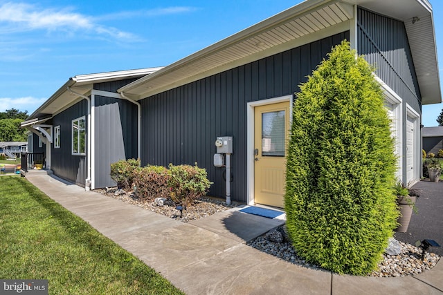 61 Bragg Dr, East Berlin, PA 17316 - view of exterior entry with a lawn and a garage