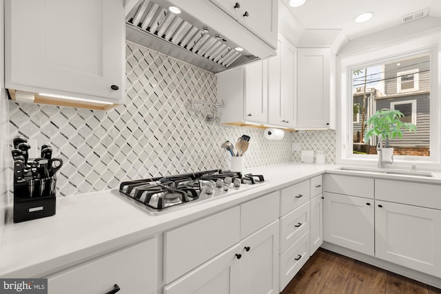 1217 Carrollsburg Pl SW, Washington, DC 20024 - kitchen with custom range hood, stainless steel gas stovetop, white cabinetry, decorative backsplash, and recessed lighting