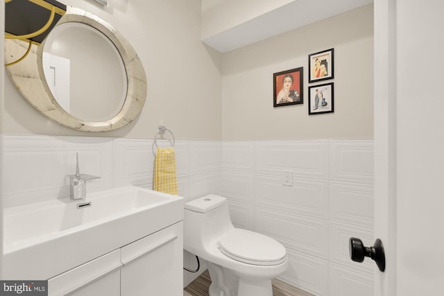 1217 Carrollsburg Pl SW, Washington, DC 20024 - bathroom featuring vanity, wainscoting, and toilet
